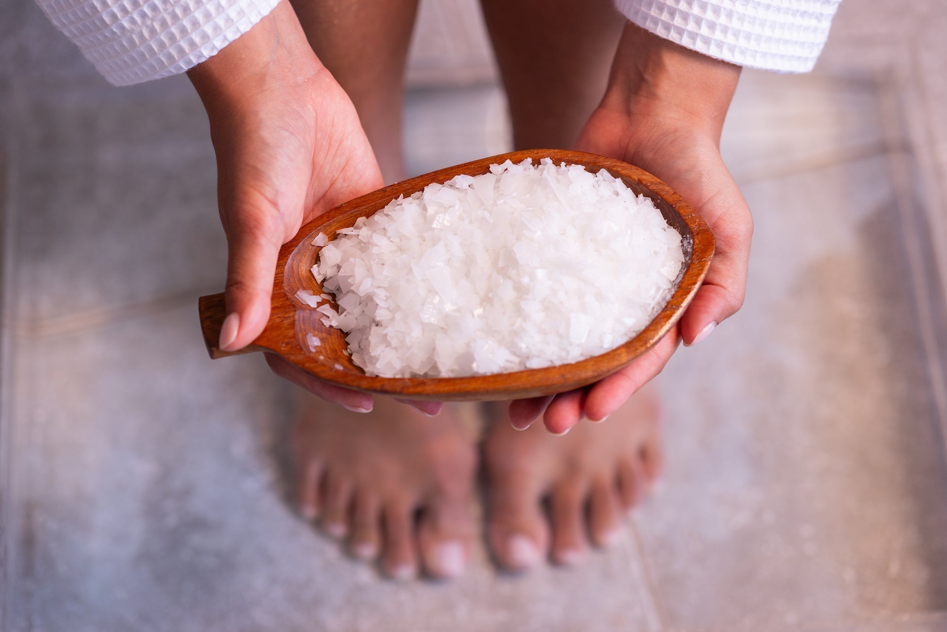 Female preparing for a magnesium flakes foot bath