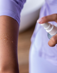 magnesium oil spray on arm for transdermal use